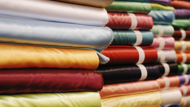 Mehrere Stapel mit Bekleidungserzeugnissen Mehrere Stapel mit Bekleidungserzeugnissen