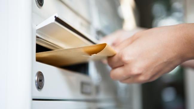 refer to: Submit a Complaint Close-up of woman's hand holding envelope and inserting in mailbox (refer to: Submit a Complaint)